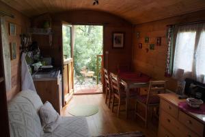 a room with a kitchen and a table in a house at Roulotte De Cabrières in Compeyre