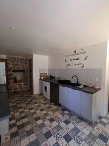 a kitchen with a sink and a counter top at Maison Typique De Montagne in Ercé +14 photos