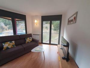 a living room with a couch and a table at Altissim Font de Ferro in Ransol