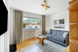 a living room with a couch and a window at Premium App Hofer Monika in Villabassa
