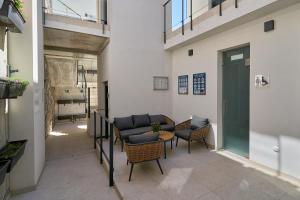 a hallway with chairs and a couch in a building at Exclusive Getaway – Ocean View in Torrox Costa +35 photos