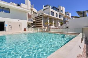 a swimming pool in front of a house at Exclusive Getaway – Ocean View in Torrox Costa