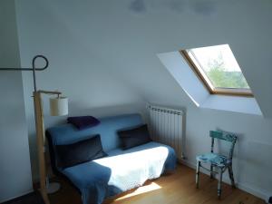 a bedroom with a blue bed and a window at Chambre D'hôtes Lesseps in Vendôme