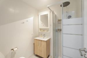 a white bathroom with a sink and a shower at Charming one bedroom Los Cristianos in Arona +15 photos