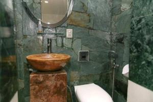 a bathroom with a wooden sink and a toilet at Casa Lavim in Bogotá
