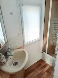 a bathroom with a sink and a window at Escale en Provence in Carqueiranne +7 photos