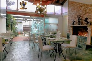 a restaurant with tables and chairs and a fireplace at Casa Lavim in Bogotá