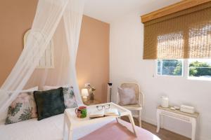 a bedroom with a white bed with a canopy at Villa Tino- Casa D in Los Llanos de Aridane +21 photos