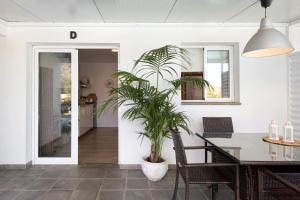 a dining room with a table and a potted plant at Villa Tino- Casa D in Los Llanos de Aridane