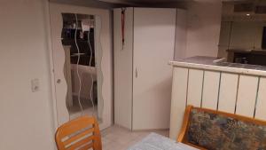 a kitchen with a refrigerator and a table and chairs at Gästezimmer Jülich mit Küche in Weil am Rhein +14 photos