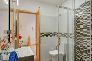 a bathroom with a shower and a toilet and a sink at Arinaga Home in Arinaga +13 photos
