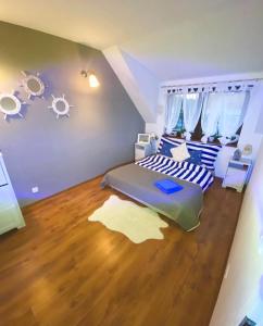 a bedroom with a bed and a wooden floor at Mazurska Oaza in Pisz +8 photos