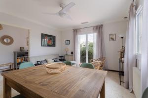 a living room with a wooden table and chairs at Maison à Argelès in Argelès-sur-Mer