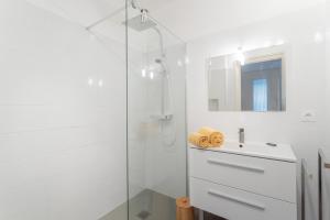 a white bathroom with a shower and a sink at Maison à Argelès in Argelès-sur-Mer +17 photos