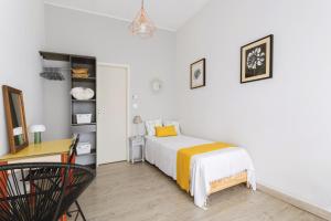 a small bedroom with a bed and a desk at Maison à Argelès in Argelès-sur-Mer