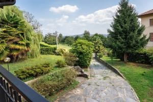 a view of a garden from a balcony at Unique Lake View In Green Park in Nebbiuno