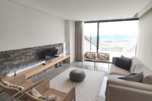 a living room with a couch and a fireplace at Douro Barcos House Local in Barcos