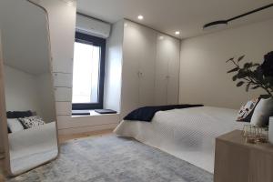 a bedroom with a large white bed and a window at Douro Barcos House Local in Barcos +29 photos