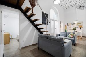 a living room with a staircase and a couch at Piso con Encanto 2 in Cádiz