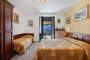 a hotel room with two beds and a balcony at Verger Plein Soleil in Saint-Pierre