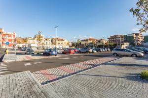 a street with cars parked in a parking lot at Pm House in Misterbianco