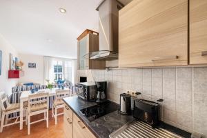 a kitchen with a stove and a counter top at Moewentraum in Malchow