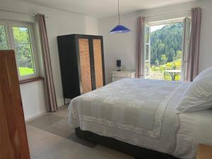 a bedroom with a bed and a large window at Weingut Kleinmonte in Leutschach