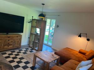 a living room with a couch and a flat screen tv at Weingut Kleinmonte in Leutschach