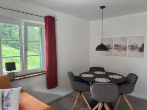 a dining room with a table and chairs and a window at Weingut Kleinmonte in Leutschach