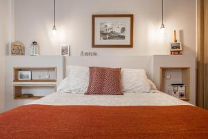 a bedroom with a large bed with a red blanket at Casa Yerida in El Cotillo +20 photos