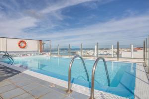 a swimming pool with a view of the ocean at Casa Yerida in El Cotillo