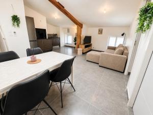 a living room with a table and chairs and a couch at Appartement Andance in Andance