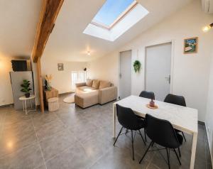 a living room with a table and a couch at Appartement Andance in Andance