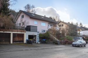a house with a car parked in front of it at Panoramablick und Ruhe in Titisee-Neustadt