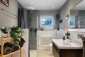 a bathroom with a sink and a shower at Panoramablick und Ruhe in Titisee-Neustadt +26 photos