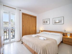 a bedroom with two beds and a window at Apartment Xisca by Interhome in Port d'Alcudia