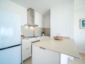 a kitchen with white cabinets and a counter top at Apartment Xisca by Interhome in Port d'Alcudia