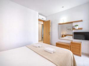a bedroom with a bed with towels on it at Apartment Xisca by Interhome in Port d'Alcudia +10 photos