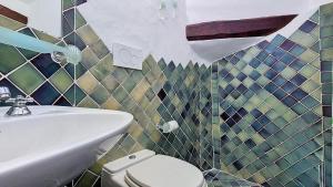a bathroom with a sink and a toilet at Monolocale Porto Sole N 4 in Baja Sardinia