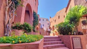 a street with stairs and flowers in an alley at Monolocale Porto Sole N 4 in Baja Sardinia
