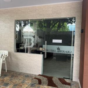 a glass door to a hotel drugstore with a sign on it at Hotel Beraka in Fortul +18 photos