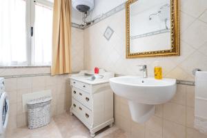 a bathroom with a sink and a mirror at Domus Luna in Giba +20 photos