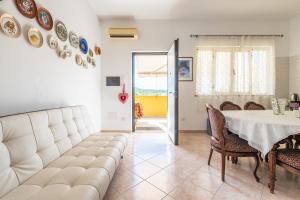 a living room with a table and a couch at Domus Luna in Giba