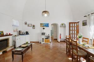 a kitchen and living room with a table and chairs at La Perla House in Anacapri
