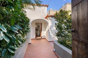 an entrance to a house with a hallway with plants at La Perla House in Anacapri