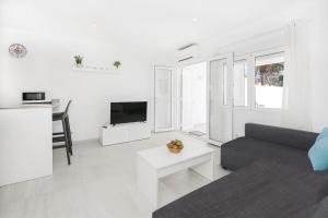 a living room with a couch and a table at Villa Aday and Ixeia in Cala Blanca