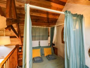 a room with a canopy bed in a cabin at Swallows Nest in Newton Abbot