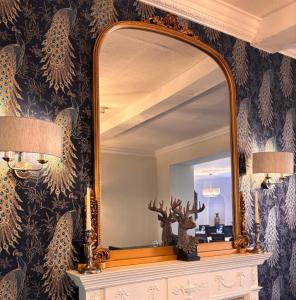 a mirror on top of a dresser in a bathroom at Corse Lawn House Hotel in Corse