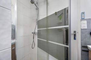 a shower in a bathroom with a glass door at Maison Kaoz Korriganez in La Boussac +15 photos