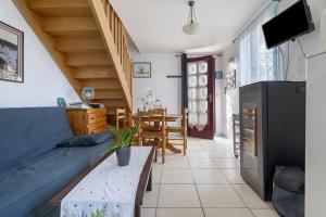 a living room with a couch and a table at Maison Kaoz Korriganez in La Boussac
